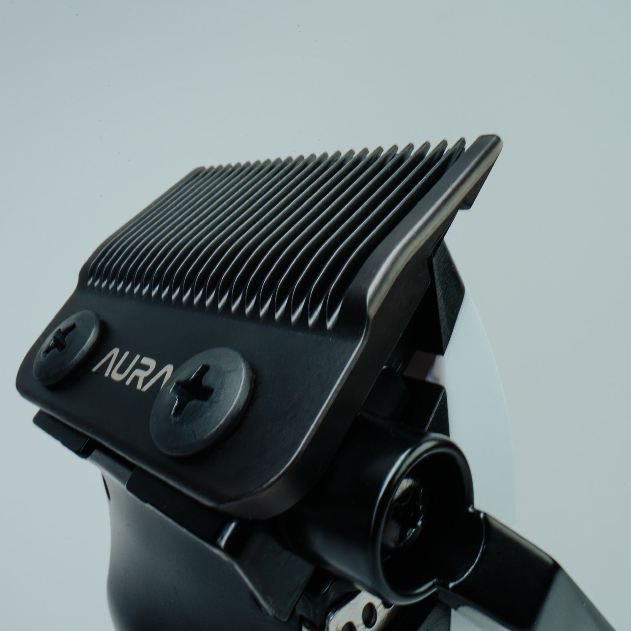 Black hair clipper with 'Aura' branding on a gray background